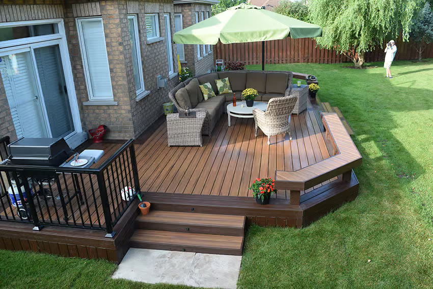 Example of a composite deck with built-in bench seating and a patio umbrella