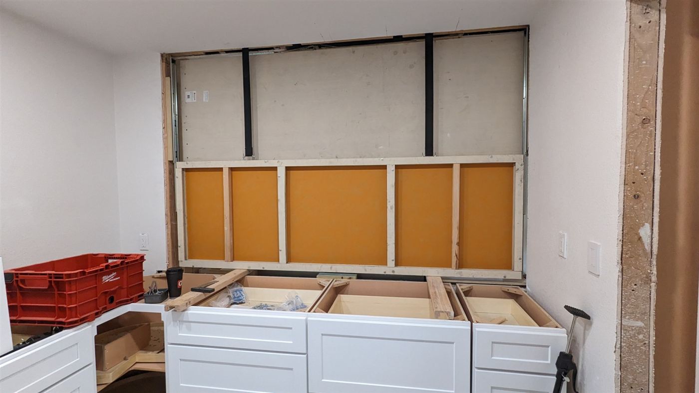 Backsplash panel opening with lift straps and mechanical framing