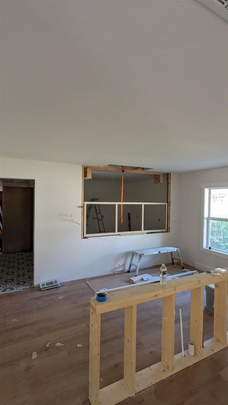 Framed pass-through opening in the wall for the butler's pantry connection