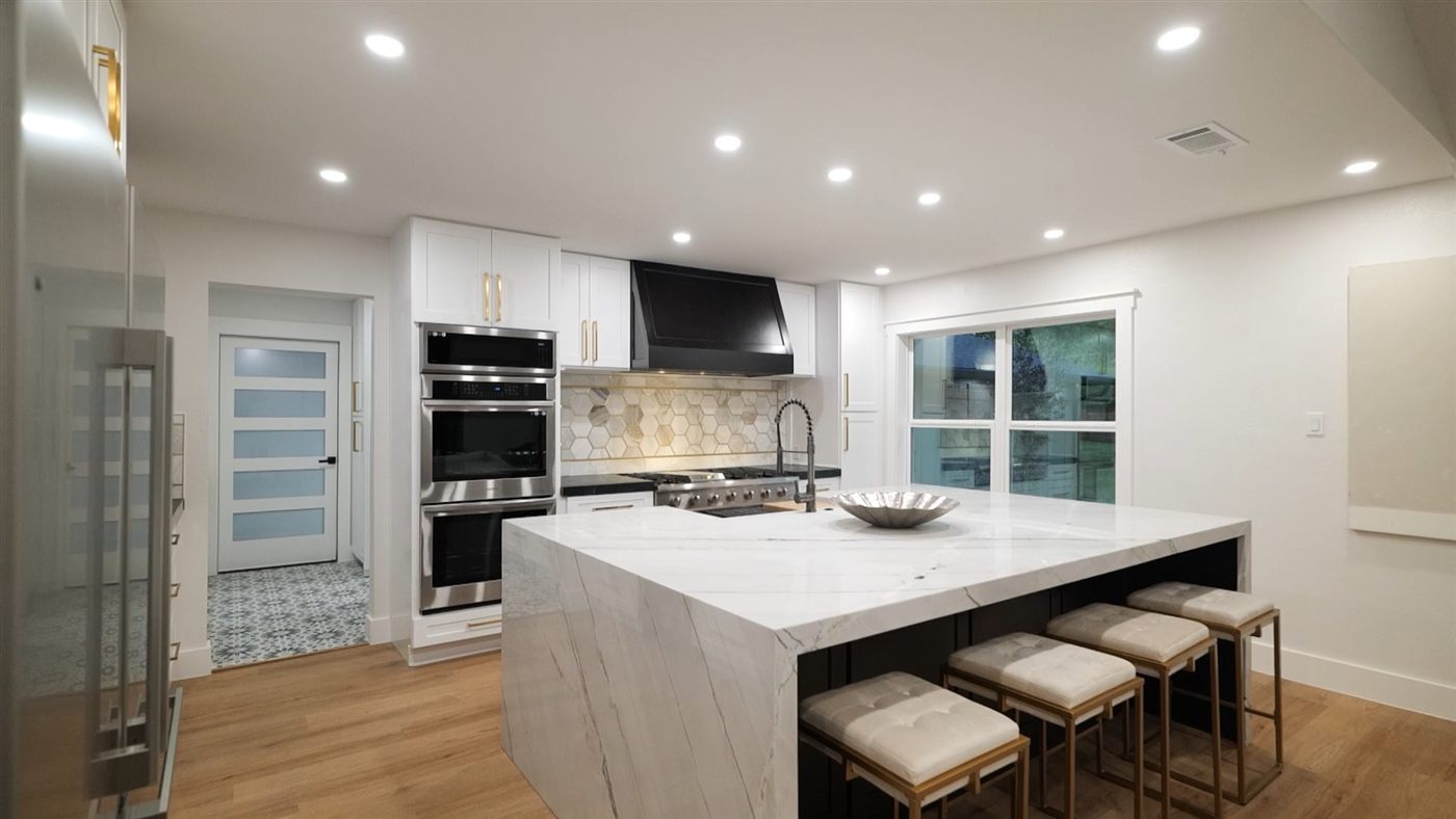 Finished kitchen and great room with waterfall island, after photo