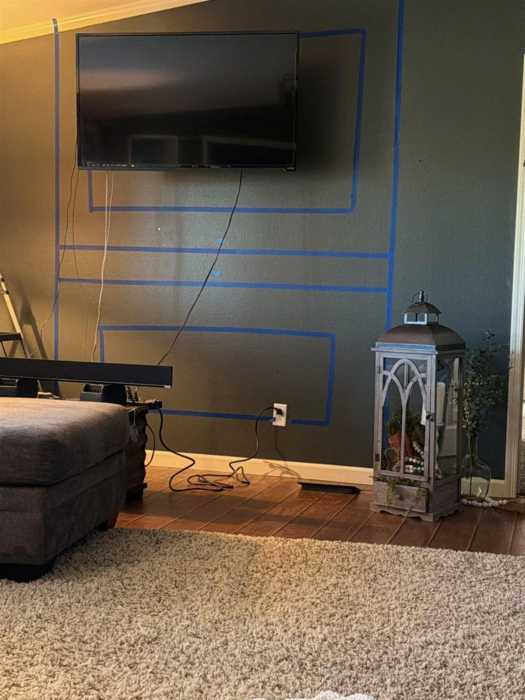 Bare wall marked out for media wall, before photo