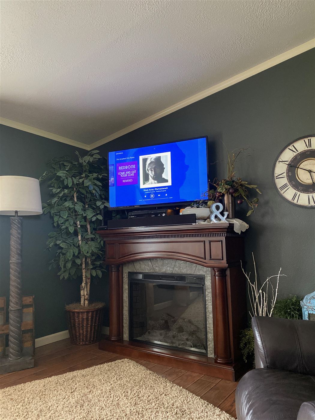 Old traditional fireplace mantel and TV setup before the media wall build